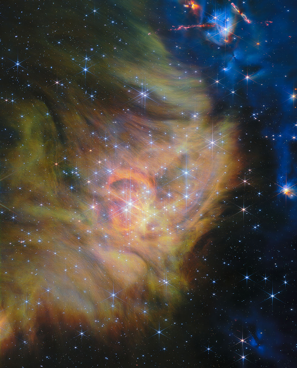 星形成領域IC 348を写したジェイムズ・ウェッブ宇宙望遠鏡の広範囲パノラマ画像。無数の若い星と、金色や青色に輝くガス・塵の雲が広がっている
